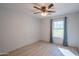 Bedroom with ceiling fan, window, and blue curtains at 17186 W Post Dr, Surprise, AZ 85388