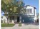 Two story house with teal garage door and manicured lawn at 17186 W Post Dr, Surprise, AZ 85388