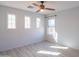Well-lit bedroom with three windows and ceiling fan at 17186 W Post Dr, Surprise, AZ 85388