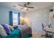 Bedroom with floral wallpaper, queen bed, and home office space at 17186 W Post Dr, Surprise, AZ 85388