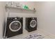 Laundry room with washer, dryer, and shelving for storage at 30009 W Monterey Dr, Buckeye, AZ 85396