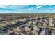 Aerial view of a community with houses featuring solar panels and desert landscaping at 30009 W Monterey Dr, Buckeye, AZ 85396