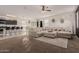 Open concept living room with sectional sofa and kitchen views at 30009 W Monterey Dr, Buckeye, AZ 85396