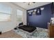 Bedroom with twin bed, dresser and wall decor at 30009 W Monterey Dr, Buckeye, AZ 85396