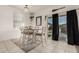 Bright dining area with a table and six chairs, near sliding glass door at 30009 W Monterey Dr, Buckeye, AZ 85396