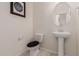 Clean and updated bathroom with pedestal sink and toilet at 30009 W Monterey Dr, Buckeye, AZ 85396