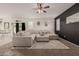 Open concept living room with sectional sofa and kitchen views at 30009 W Monterey Dr, Buckeye, AZ 85396