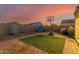 Artificial turf backyard with basketball court and partial home view at 30009 W Monterey Dr, Buckeye, AZ 85396