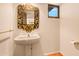 Charming bathroom features an ornate mirror and pedestal sink at 10044 E Graythorn Dr, Scottsdale, AZ 85262