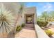 Inviting entryway with a wooden door and desert plants at 10044 E Graythorn Dr, Scottsdale, AZ 85262