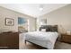 Bright bedroom with a double bed, nightstands and large window at 52320 W Foothill Trl, Maricopa, AZ 85139