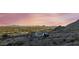 House nestled in mountains with scenic sunset views at 52320 W Foothill Trl, Maricopa, AZ 85139