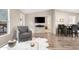 Bright living room with hardwood floors, a sitting area, and dining space at 52320 W Foothill Trl, Maricopa, AZ 85139