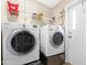 Laundry room with washer, dryer and shelving at 52320 W Foothill Trl, Maricopa, AZ 85139