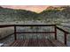 Deck with three metal stools and mountain views at sunset at 52320 W Foothill Trl, Maricopa, AZ 85139