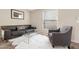 Cozy living room features a leather sofa, armchair, and coffee table at 52320 W Foothill Trl, Maricopa, AZ 85139