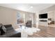 Open living room with hardwood floors and views into bedroom at 52320 W Foothill Trl, Maricopa, AZ 85139