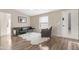 Living room with hardwood floors, leather sofa and chair, and entryway at 52320 W Foothill Trl, Maricopa, AZ 85139