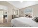 Bedroom with double bed, dresser and access to another room at 52320 W Foothill Trl, Maricopa, AZ 85139