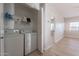 Bright laundry room with washer, dryer, and shelving for storage at 930 N Mesa Dr # 1039, Mesa, AZ 85201