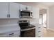 Updated kitchen with white cabinets and stainless steel appliances at 930 N Mesa Dr # 1039, Mesa, AZ 85201