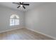 Bedroom with wood-look floors and an arched window at 930 N Mesa Dr # 1039, Mesa, AZ 85201