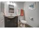 Clean bathroom with dark vanity, updated fixtures and a toilet at 3135 N 34Th St, Phoenix, AZ 85018