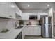 Modern kitchen with white cabinets, stainless steel appliances, and quartz countertops at 3135 N 34Th St, Phoenix, AZ 85018