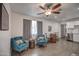 Living area with teal armchairs and wood-look floors at 3135 N 34Th St, Phoenix, AZ 85018