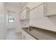 Laundry room with cabinets, sink, and hanging rod at 15528 E Chicory Dr, Fountain Hills, AZ 85268