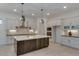 Modern kitchen with white cabinets, a large island, and geometric backsplash at 15528 E Chicory Dr, Fountain Hills, AZ 85268