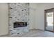 Living area with a modern fireplace and brick wall at 15528 E Chicory Dr, Fountain Hills, AZ 85268