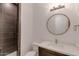 Modern bathroom with a round mirror and dark vanity at 15528 E Chicory Dr, Fountain Hills, AZ 85268