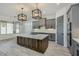 Open kitchen boasting a large island, stylish light fixtures and gray cabinetry at 15528 E Chicory Dr, Fountain Hills, AZ 85268