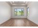 Bright bedroom with wood-look tile flooring and large window at 15522 E Chicory Dr, Fountain Hills, AZ 85268