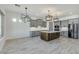 Open concept kitchen with gray cabinets, center island and wood flooring at 15522 E Chicory Dr, Fountain Hills, AZ 85268