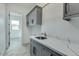 Laundry room with gray cabinets, white countertop, and utility sink at 15522 E Chicory Dr, Fountain Hills, AZ 85268
