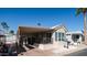 Tan mobile home with covered patio and mature landscaping at 915 Mineshaft Dr, Apache Junction, AZ 85119