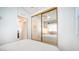 Bedroom with mirrored closet and view into another room at 915 Mineshaft Dr, Apache Junction, AZ 85119