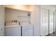 Laundry closet with washer, dryer, and shelving at 915 Mineshaft Dr, Apache Junction, AZ 85119