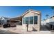 Mobile home with covered carport and front yard at 915 Mineshaft Dr, Apache Junction, AZ 85119