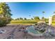 Peaceful backyard with water feature and golf course view at 402 W Beechnut Pl, Sun Lakes, AZ 85248