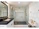 Modern bathroom with walk-in shower, frameless glass, and black and white tile at 8014 E Del Tesoro Dr, Scottsdale, AZ 85258
