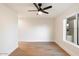 Bright bedroom featuring light hardwood floors and large window at 8014 E Del Tesoro Dr, Scottsdale, AZ 85258