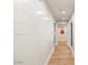 Long hallway with light wood floors and shiplap walls at 8014 E Del Tesoro Dr, Scottsdale, AZ 85258