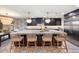 Modern kitchen with a large island, ample cabinetry, and stylish pendant lights at 8014 E Del Tesoro Dr, Scottsdale, AZ 85258