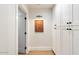 Bright hallway with white walls, wood floors, and built-in storage at 8014 E Del Tesoro Dr, Scottsdale, AZ 85258