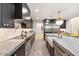 Sleek kitchen with dark cabinetry, granite counters, and high-end appliances at 8014 E Del Tesoro Dr, Scottsdale, AZ 85258