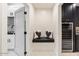 Convenient laundry room with built-in seating and storage at 8014 E Del Tesoro Dr, Scottsdale, AZ 85258