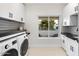 Bright laundry room with washer, dryer, and ample counter space at 8014 E Del Tesoro Dr, Scottsdale, AZ 85258